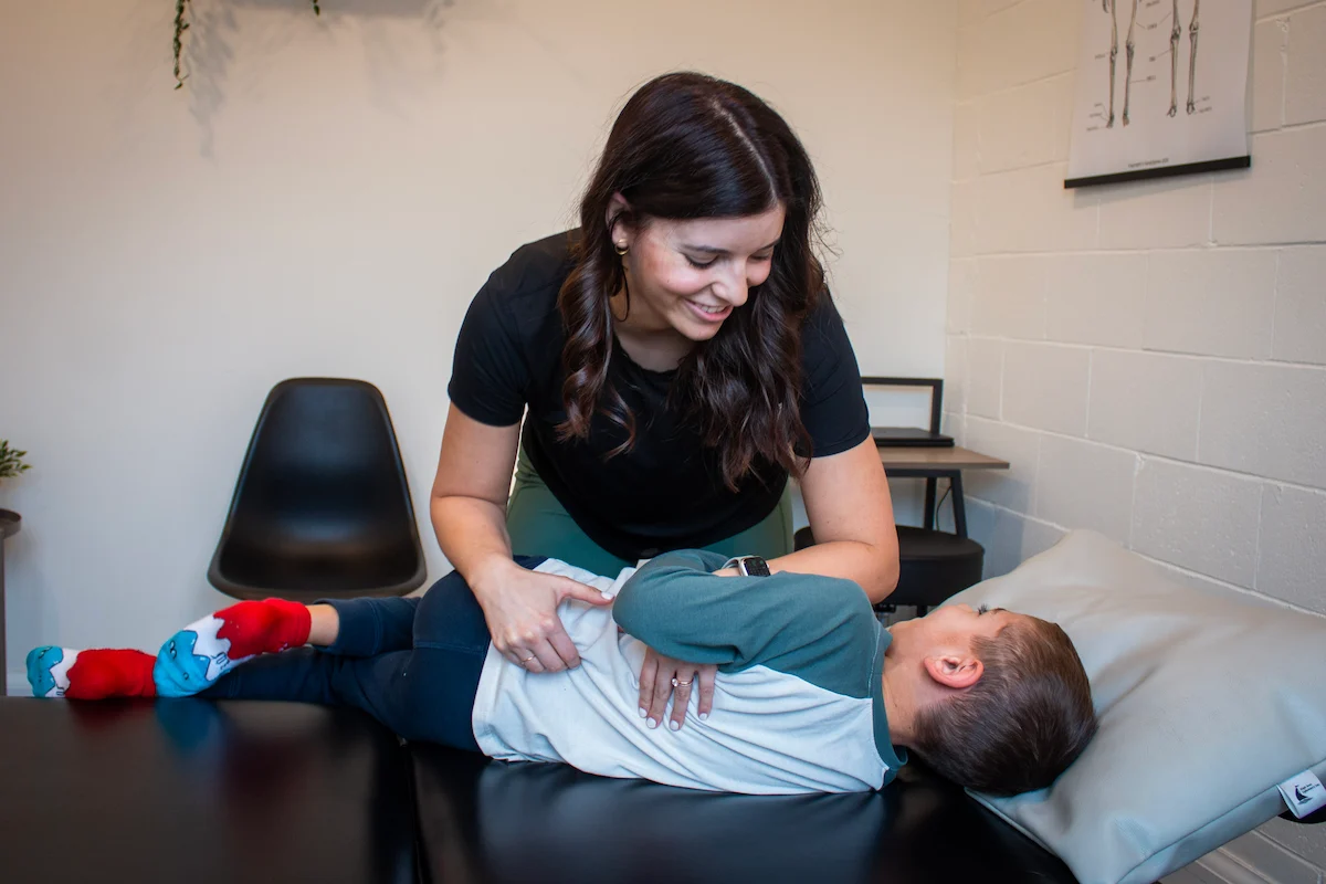 Dr. Natalie Lopez providing gentle pediatric chiropractic care at Tip Top Health